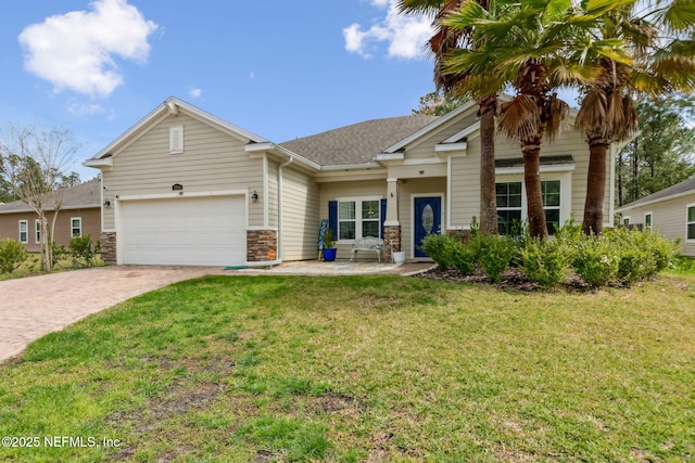 view of front of home with a shingled roof, a front lawn, a garage, stone siding, and decorative driveway