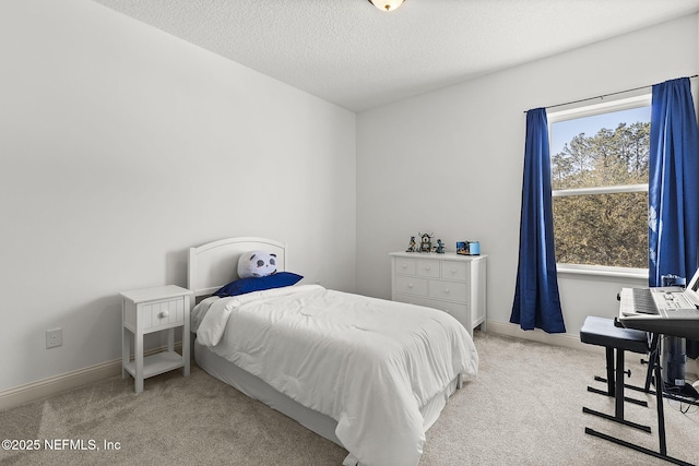 carpeted bedroom with multiple windows, a textured ceiling, and baseboards