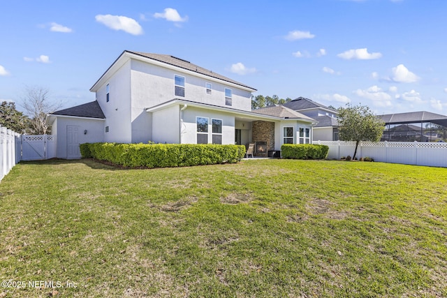 back of property featuring a gate, a yard, a fenced backyard, and stucco siding