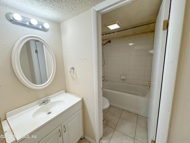 bathroom featuring tile patterned flooring, washtub / shower combination, toilet, vanity, and a textured ceiling