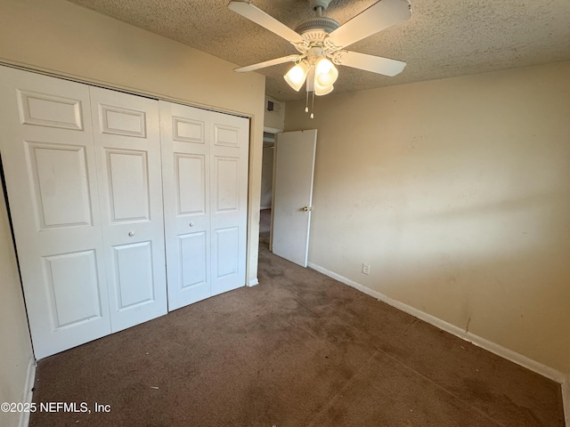 unfurnished bedroom featuring baseboards, ceiling fan, carpet, a closet, and a textured ceiling