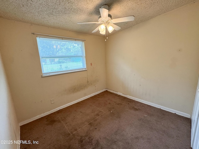 spare room featuring baseboards, carpet floors, a textured ceiling, and a ceiling fan