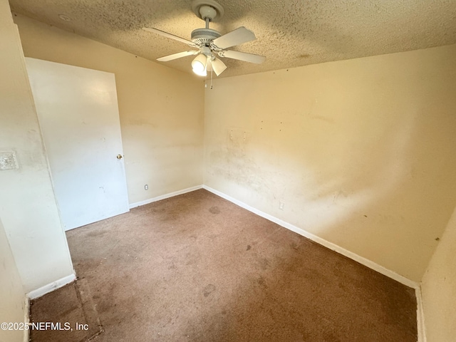 empty room featuring a ceiling fan, baseboards, a textured ceiling, and carpet flooring