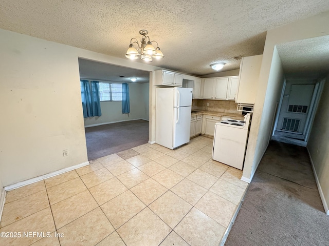 kitchen featuring light countertops, decorative backsplash, light tile patterned flooring, white appliances, and a textured ceiling