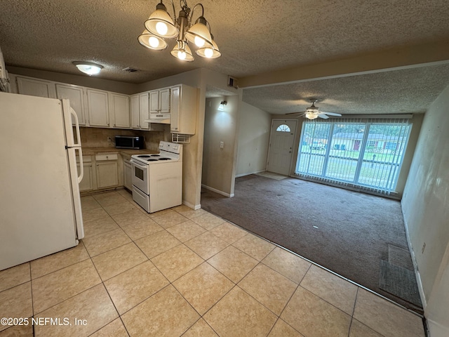 kitchen with white appliances, light tile patterned floors, light colored carpet, and under cabinet range hood