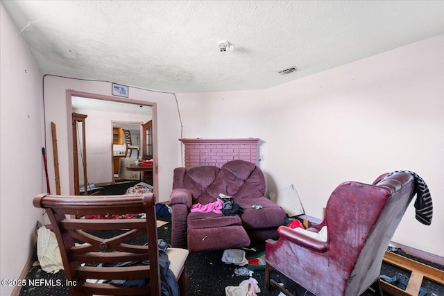 living room with visible vents and a textured ceiling