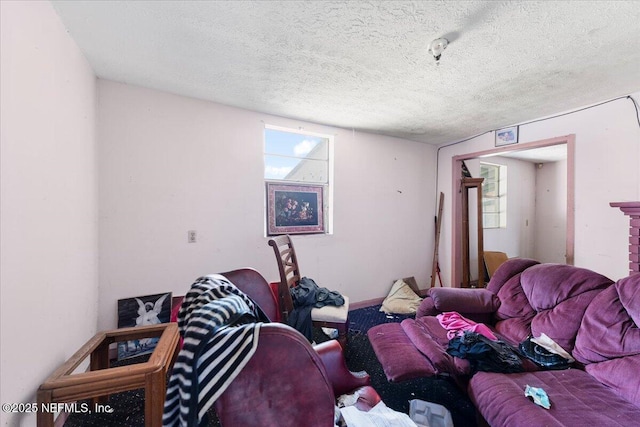 living area featuring a textured ceiling