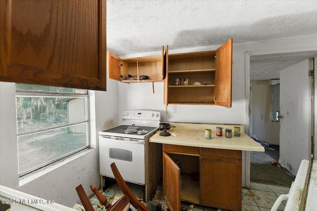 kitchen featuring light countertops, brown cabinetry, a textured ceiling, white electric range, and open shelves