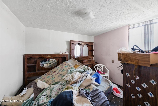 bedroom featuring multiple windows and a textured ceiling