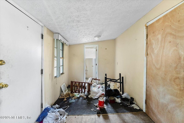 unfurnished room featuring a textured ceiling