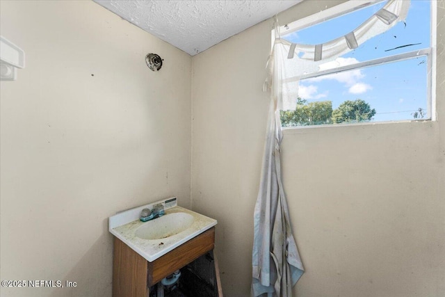 bathroom featuring a textured ceiling and vanity