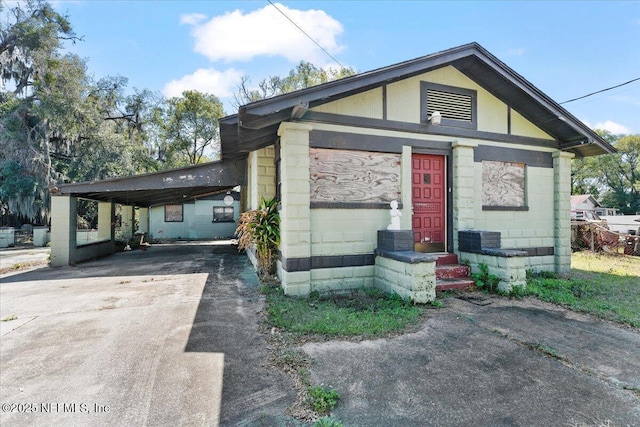 view of front of property featuring concrete block siding and driveway