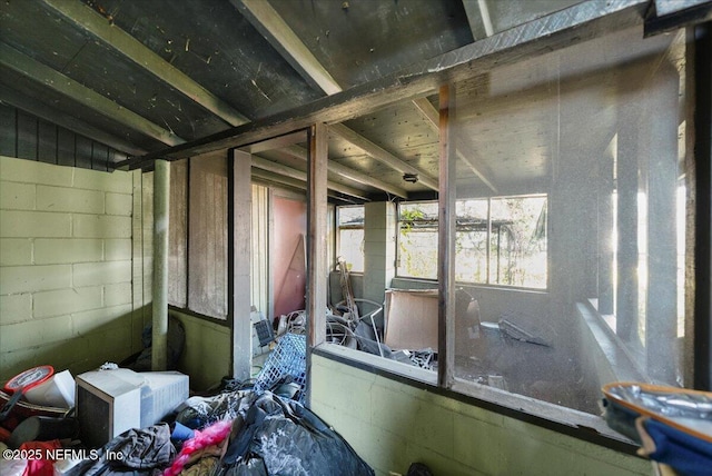 miscellaneous room featuring lofted ceiling and concrete block wall