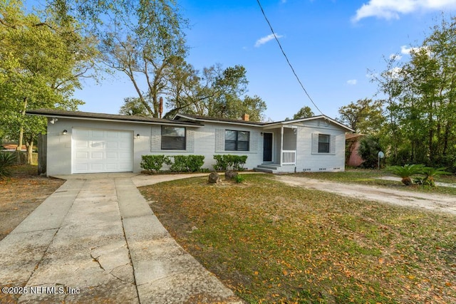 single story home featuring driveway, a front yard, and a garage