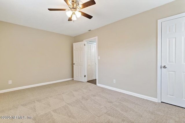 unfurnished bedroom featuring a ceiling fan, carpet flooring, visible vents, and baseboards