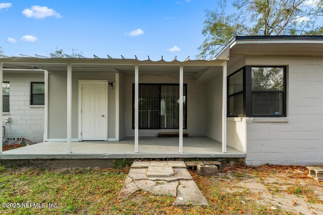 entrance to property with concrete block siding