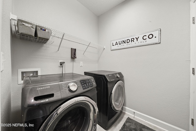 laundry room featuring laundry area, baseboards, and washer and clothes dryer