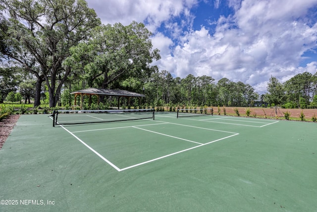 view of tennis court featuring a gazebo and fence