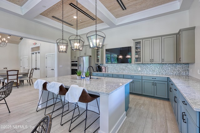 kitchen featuring wooden ceiling, light wood-style flooring, a notable chandelier, and a sink