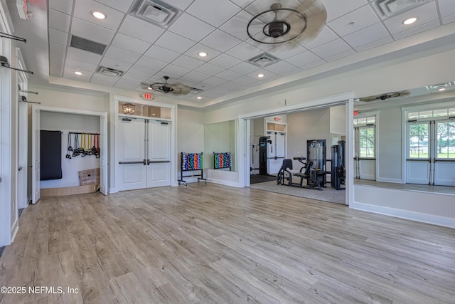 exercise room with visible vents and light wood-style flooring