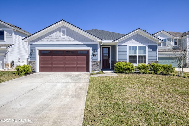 craftsman house with a garage, concrete driveway, a front yard, and stone siding