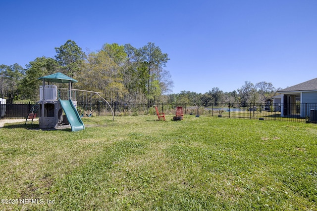 view of yard with fence and a playground