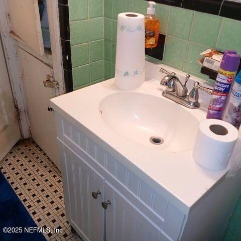 bathroom featuring tile patterned floors, tile walls, and vanity