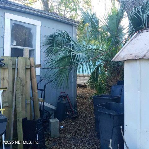 view of side of home featuring fence