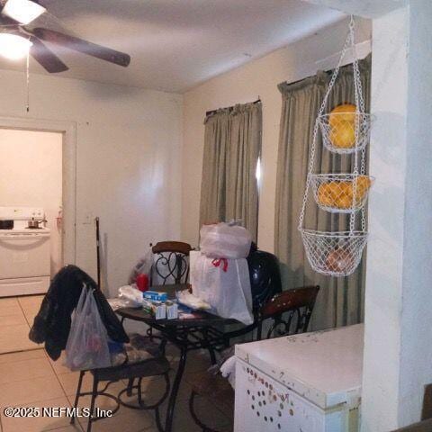 dining area with tile patterned floors, washer / clothes dryer, and a ceiling fan