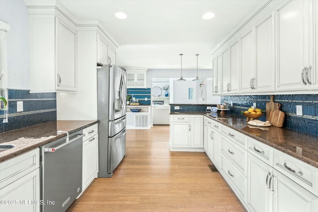 kitchen with tasteful backsplash, recessed lighting, stainless steel appliances, light wood-style floors, and white cabinets