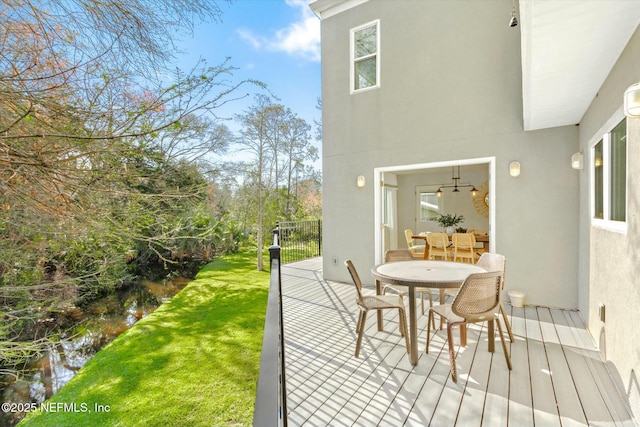 wooden terrace featuring a yard