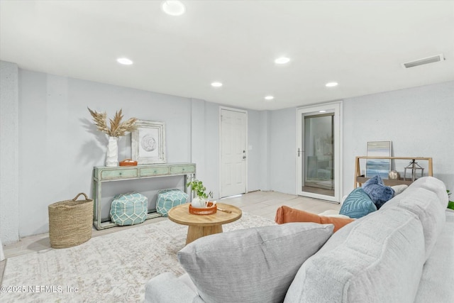 living room with tile patterned flooring, recessed lighting, and visible vents