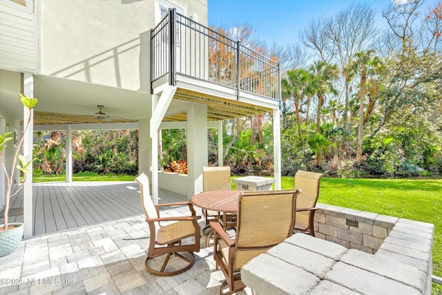 view of patio / terrace featuring a balcony, outdoor dining area, and a ceiling fan