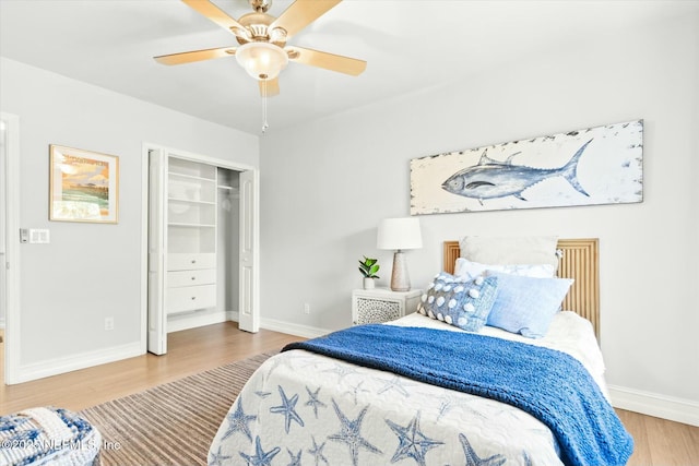 bedroom featuring a closet, ceiling fan, baseboards, and wood finished floors