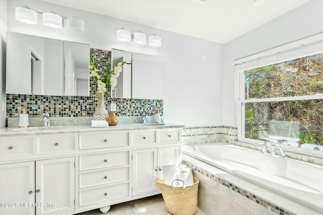 full bathroom with a bath, backsplash, and a sink