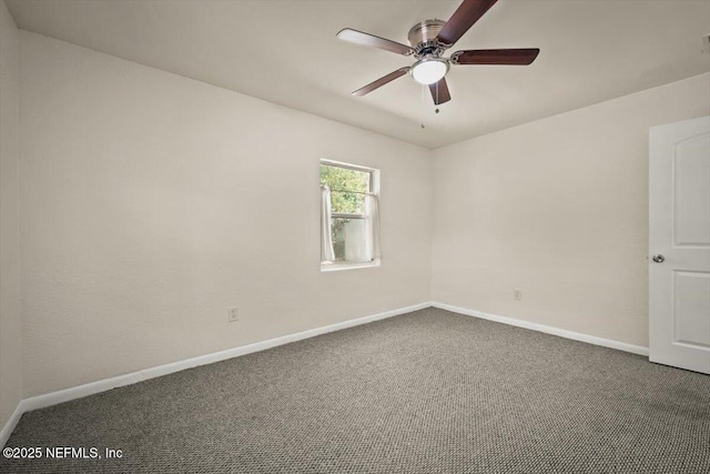 carpeted spare room featuring baseboards and ceiling fan