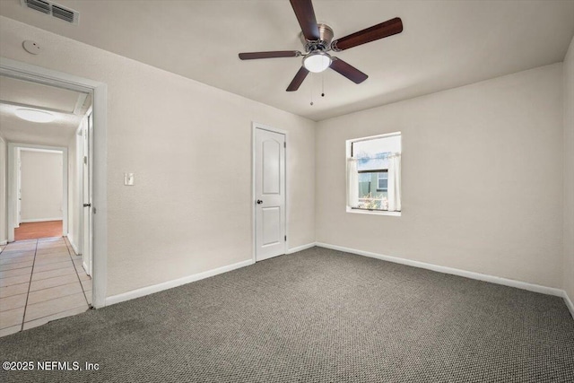 unfurnished bedroom featuring baseboards, visible vents, carpet floors, and ceiling fan