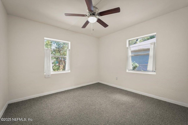 empty room featuring baseboards, carpet, and a ceiling fan