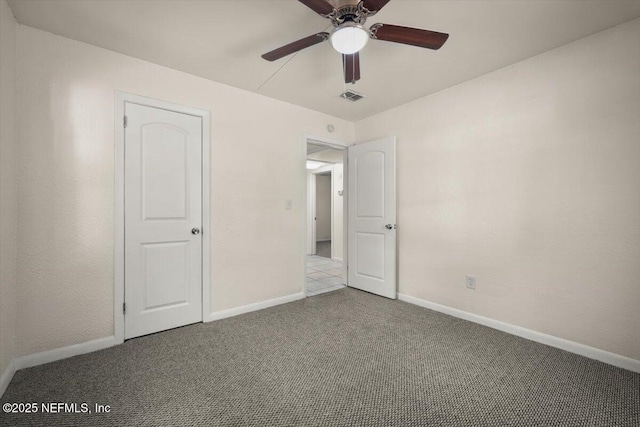 unfurnished bedroom featuring a ceiling fan, baseboards, visible vents, and carpet floors