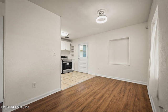 interior space featuring baseboards and light wood-type flooring