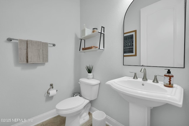 163 Medio Dr, Saint Augustine, FL 32095 - bathroom with tile patterned floors, toilet, baseboards, and a sink