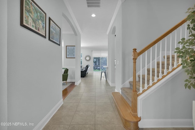 163 Medio Dr, Saint Augustine, FL 32095 - hall with visible vents, crown molding, baseboards, light tile patterned floors, and arched walkways