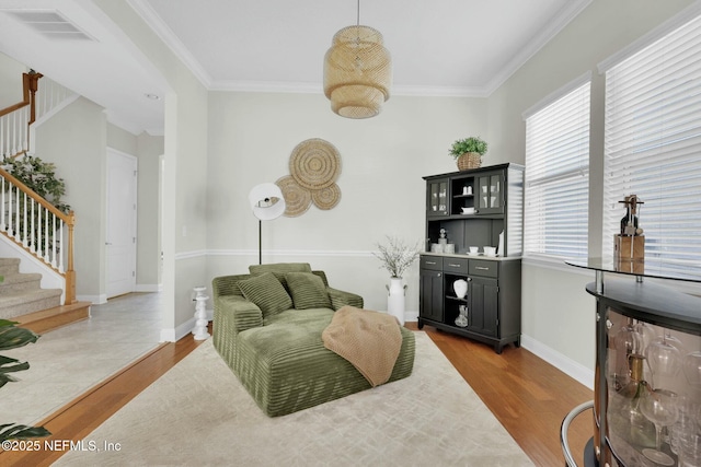 163 Medio Dr, Saint Augustine, FL 32095 - living area featuring visible vents, baseboards, stairway, ornamental molding, and wood finished floors