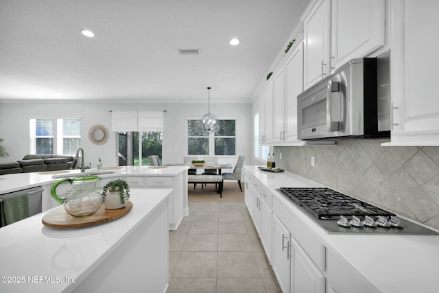 163 Medio Dr, Saint Augustine, FL 32095 - kitchen featuring visible vents, decorative backsplash, stainless steel appliances, white cabinetry, and a sink