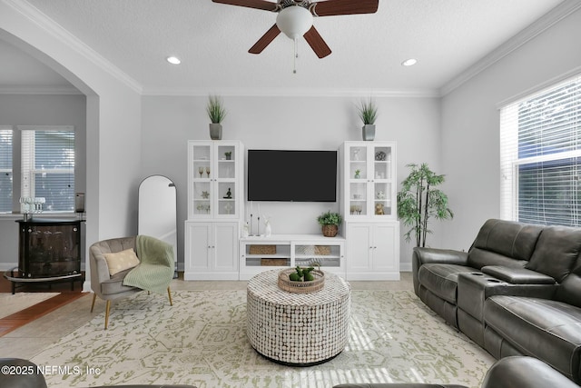 163 Medio Dr, Saint Augustine, FL 32095 - living area with ornamental molding, a ceiling fan, a textured ceiling, recessed lighting, and arched walkways