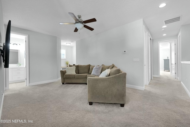 163 Medio Dr, Saint Augustine, FL 32095 - living room with a ceiling fan, baseboards, visible vents, a textured ceiling, and light carpet