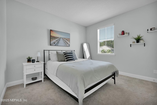 163 Medio Dr, Saint Augustine, FL 32095 - bedroom with light colored carpet, a textured ceiling, and baseboards