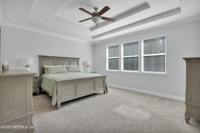 163 Medio Dr, Saint Augustine, FL 32095 - bedroom featuring baseboards, ceiling fan, a textured ceiling, a raised ceiling, and light carpet