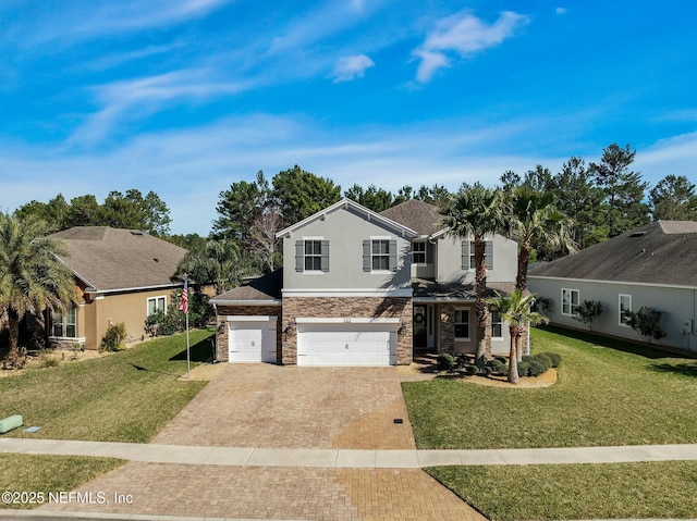 163 Medio Dr, Saint Augustine, FL 32095 - traditional-style home featuring a front lawn, decorative driveway, stone siding, and stucco siding