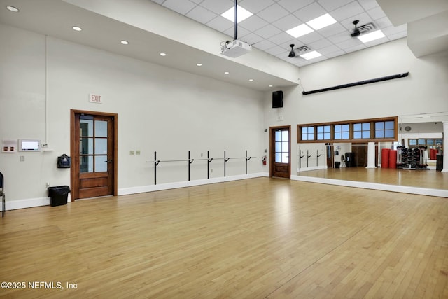163 Medio Dr, Saint Augustine, FL 32095 - interior space featuring a drop ceiling, a high ceiling, baseboards, and wood finished floors